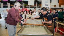 H.E. Mr. Karlis Eihenbaums，ambassador of Latvia to China, tries his hand at the traditional craft of Xuan papermaking.